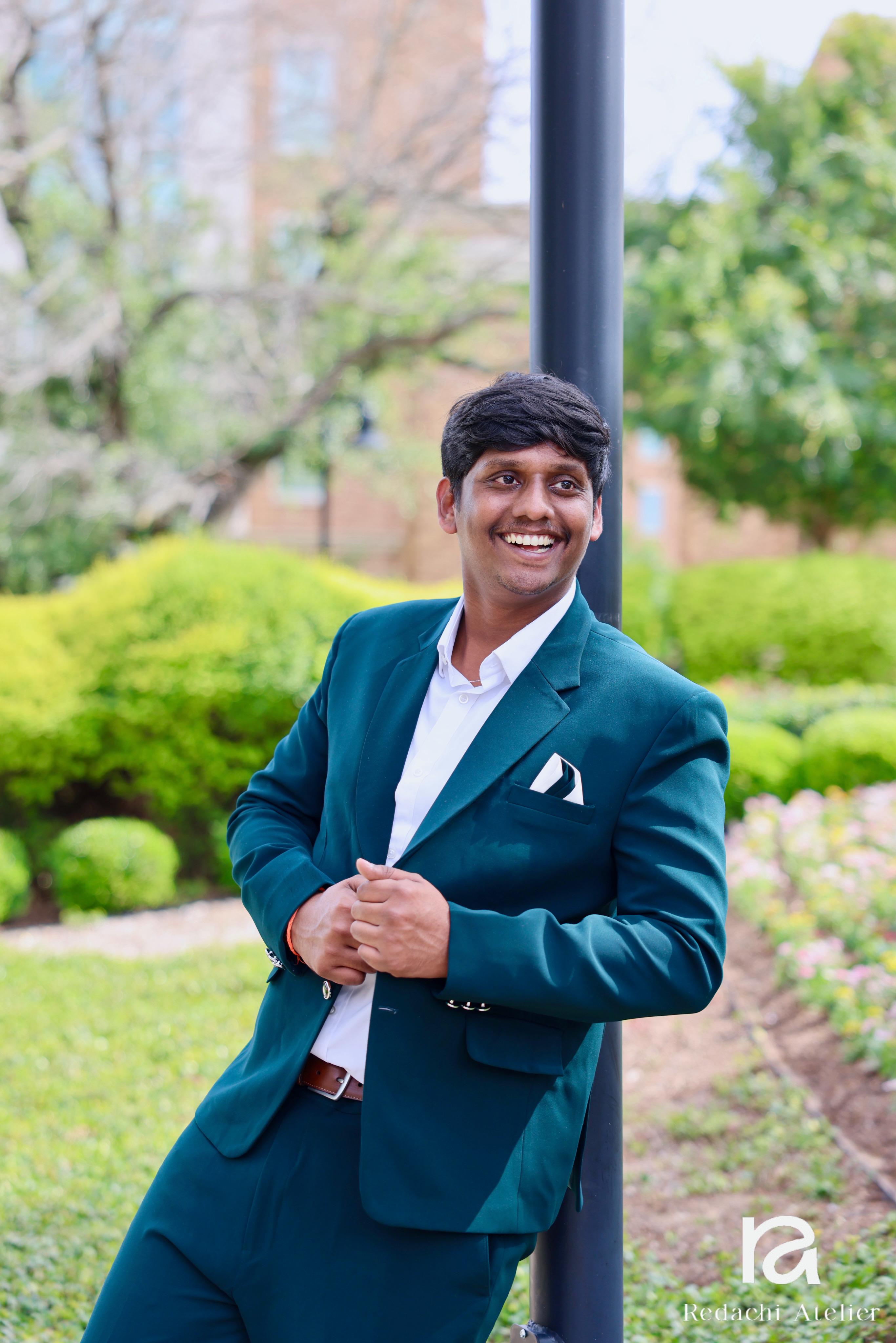 Client Raju in a Redachi Atelier emerald green suit on his Texas college campus