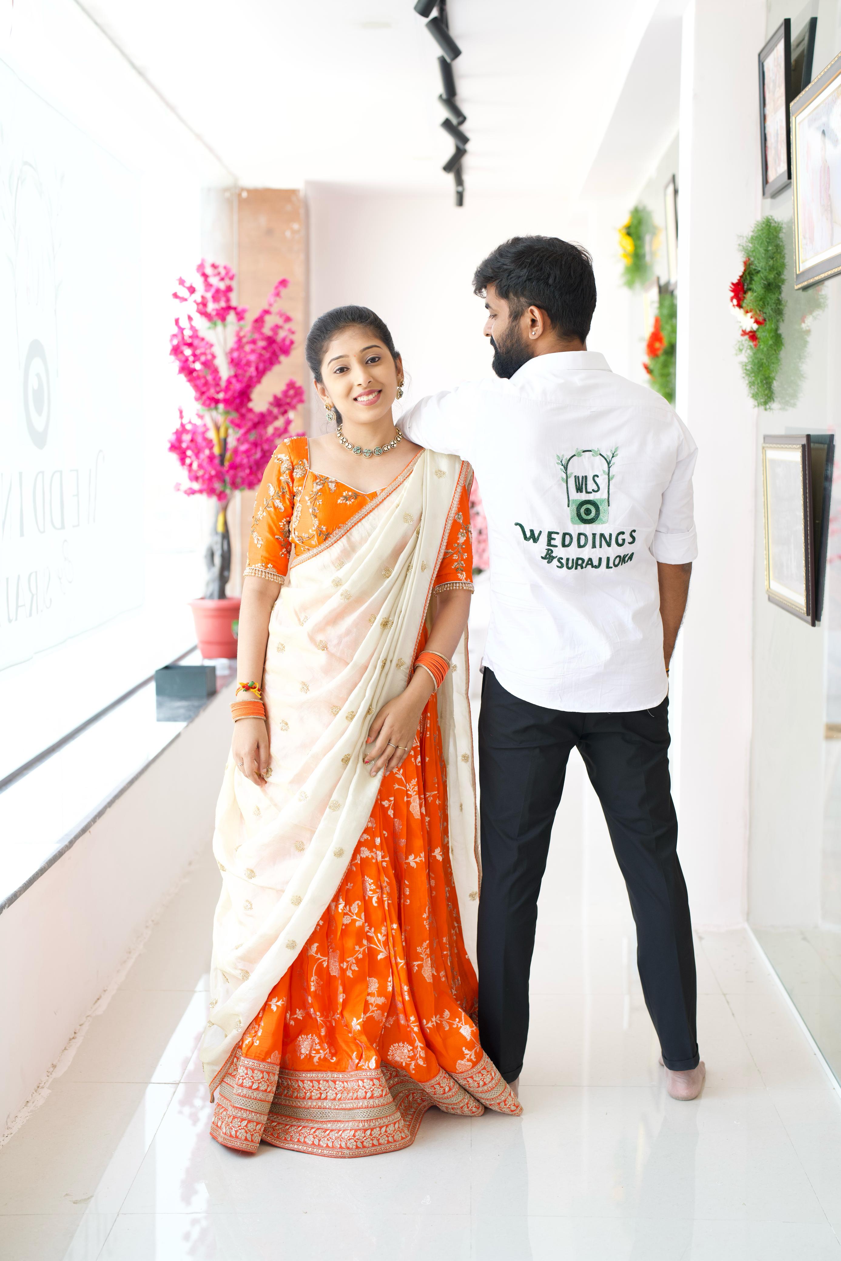 Suraj Loka in a Redachi Atelier shirt with the Weddings by Suraj Loka logo embroidered across the back, next to Suraksha